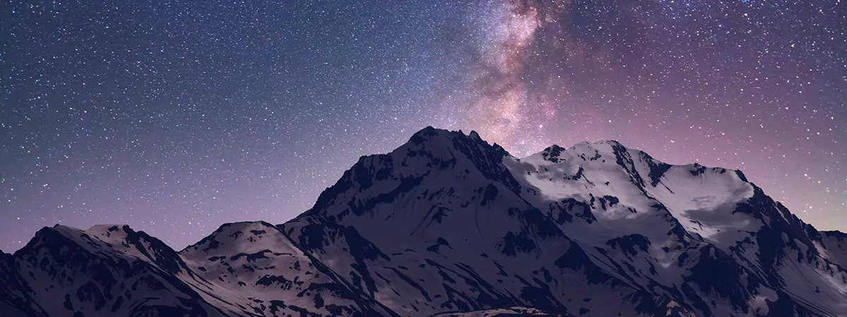 Night Landscape. Beautiful Snow Covered Mountains In The Starry Night With Milky Way Galaxy.